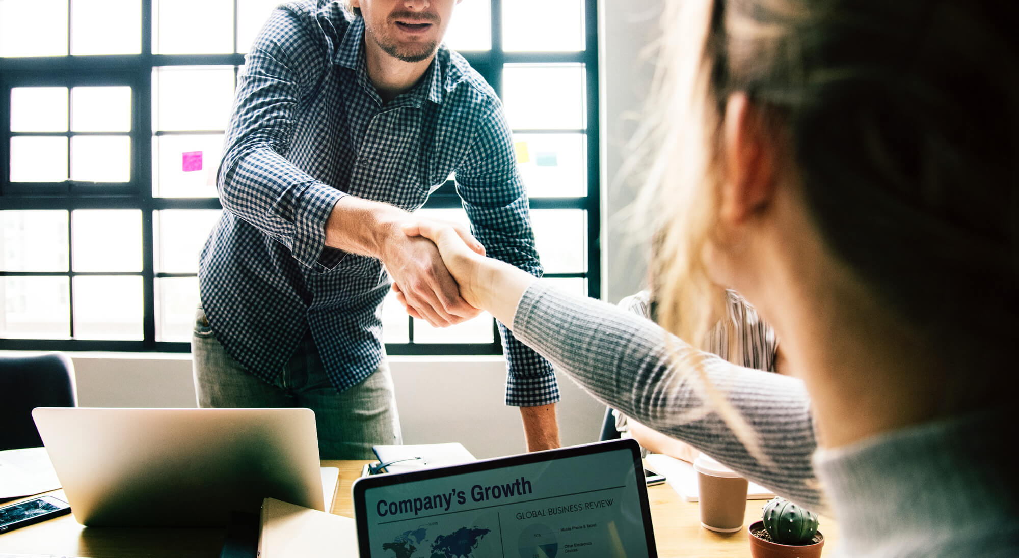 a man shaking hands with a woman